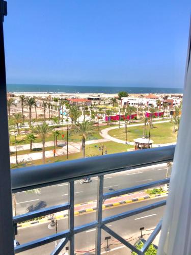 a balcony with a view of a beach and the ocean at Jewel Port Said Hotel in Port Said