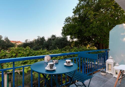 a blue table with two cups of coffee on a balcony at Rilassunte Luxury apartments in Potos