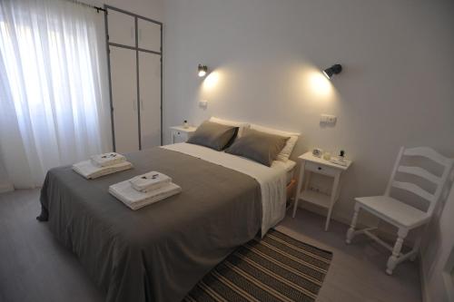 a bedroom with a bed with two towels on it at Lagos Central Apartments Ap 9 in Lagos