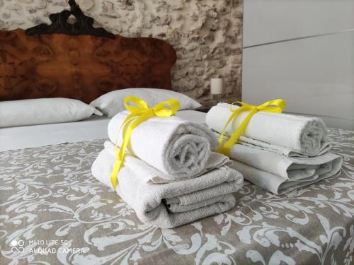 a pile of towels sitting on top of a bed at Ammira in Syracuse