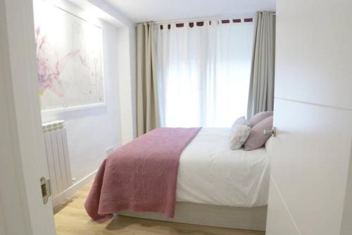 Postel nebo postele na pokoji v ubytování VUT La Casa de las Flores