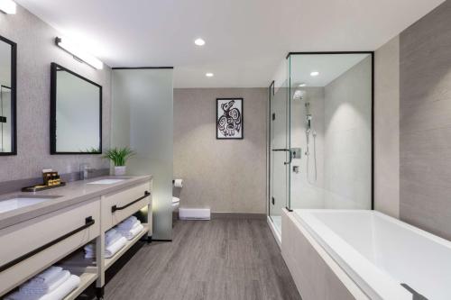 a bathroom with a tub and a sink and a shower at Best Western Plus Tin Wis Resort in Tofino