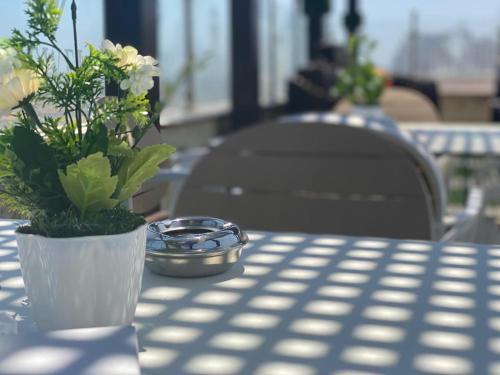 a table with a bowl of flowers on a table at Jewel Port Said Hotel in Port Said