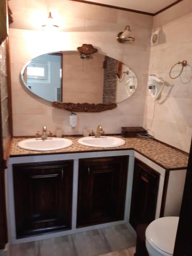 a bathroom with two sinks and a mirror at Casa Silvia in Constanţa