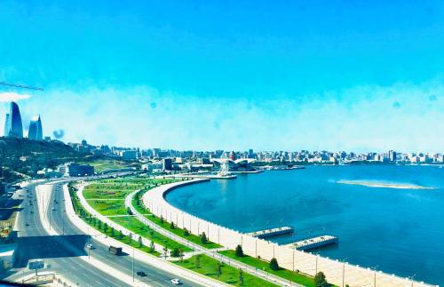 a view of a river with a city in the background at Golden Coast in Baku