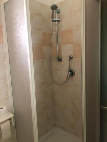 a shower with a shower head in a bathroom at Il Portichetto in LʼAquila