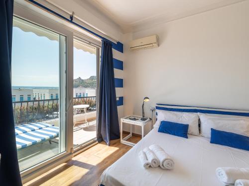 a bedroom with a bed and a large window at Il Profumo del Mare GuestHouse in Cagliari
