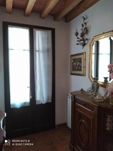 a room with a black door and a mirror at Mare Colline Relax in Montignoso