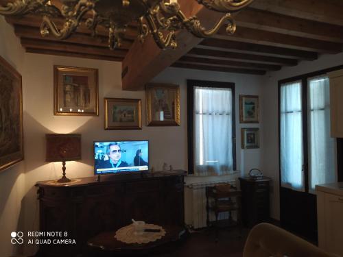 a living room with a tv on a wall at Mare Colline Relax in Montignoso