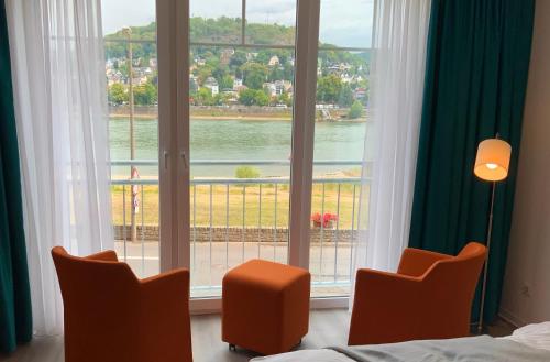 a bedroom with a large window with a view of the water at RheinVilla ARTE in Remagen