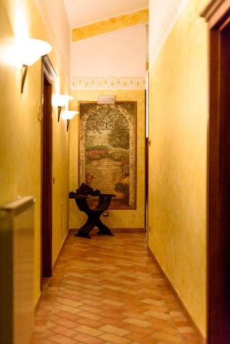 a hallway with a table and a painting on the wall at Vecchio Mulino in Castel del Giudice