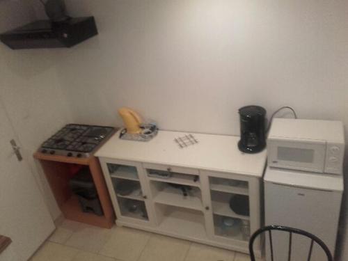 a small kitchen with a stove and a microwave at jolie appartement centre de Fismes in Fismes