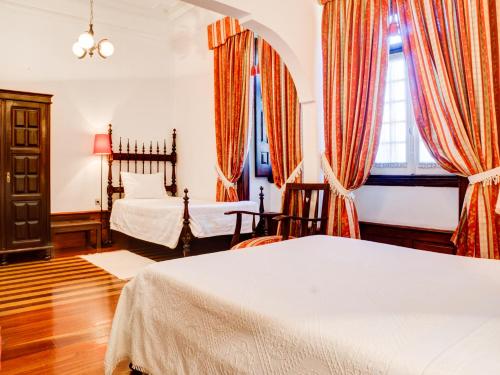 Кровать или кровати в номере Hotel Residencial Alentejana