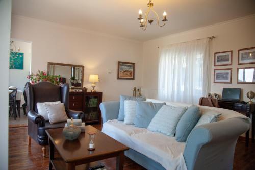 a living room with a couch and a table at Lorantina House_ Holidays in Corfu in Spartýlas