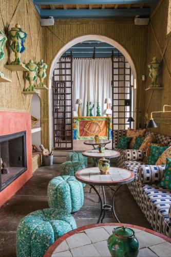 a living room with couches and tables and a fireplace at La Sacristía in Tarifa