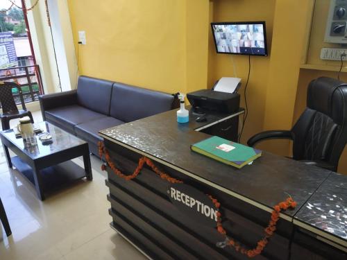 a waiting room with a couch and a table at HOTEL AWADH KAILASH in Bahraich