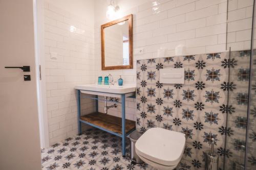 a bathroom with a toilet and a sink at Mathias Rex in Szentendre