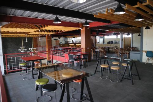 a room with tables and chairs in a restaurant at bumimakhraja syariah 4 in Bandung
