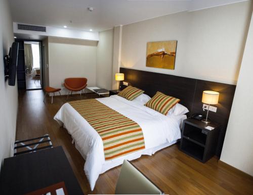 Postel nebo postele na pokoji v ubytování Amérian Puerto Rosario Hotel