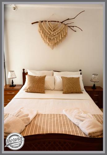 a bedroom with a large bed with white sheets and pillows at Dorvin Apartments in Dhërmi