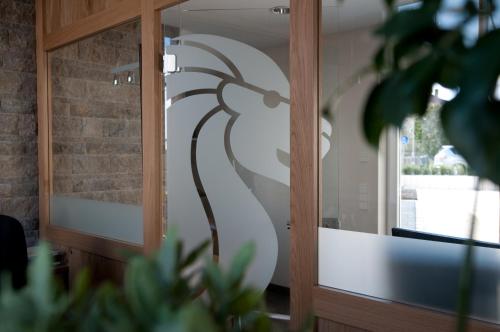 a glass door with a painting of a tree on it at Hotel & Gasthof Löwen in Ulm