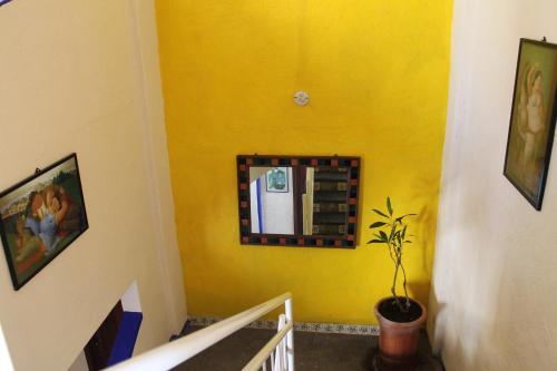 a hallway with a yellow wall with a refrigerator at Pargos Hotel & Cowork in Puerto Escondido