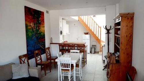 a kitchen and dining room with a table and chairs at Gîte le tréportais in Le Tréport