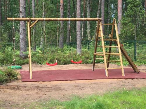 an empty playground with a ladder and swings at SPLIFE plus in Kuru