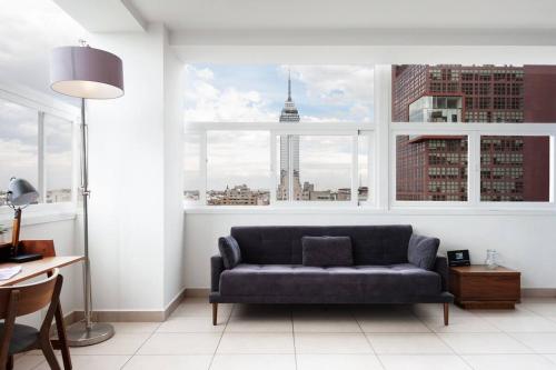 a living room with a couch in front of a window at LOFT DE LUJO / MIRADOR ALAMEDA CENTRAL in Mexico City