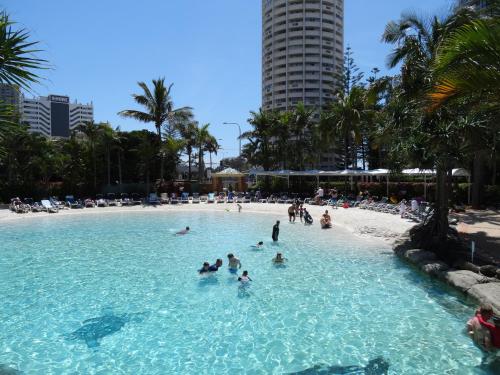 a group of people in a swimming pool on a beach at Crown Towers in Gold Coast