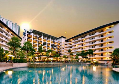 a swimming pool in front of a hotel at Sunday Wongamat Privacy Pattaya in North Pattaya