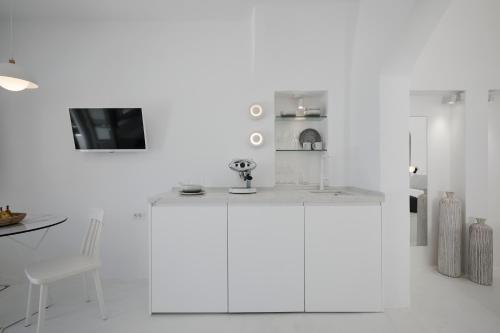 a kitchen with white walls and a white counter top at Divine View Sol Homes in Fira