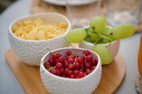 three bowls of fruit sitting on a cutting board at Calamarina B&B in Vietri sul Mare