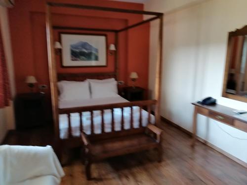 a hotel room with a bed and a mirror at Magda's Hotel Apartments in Parga