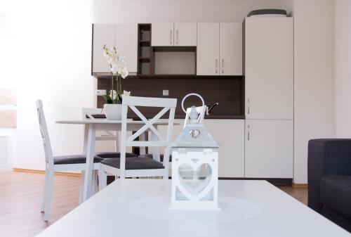 a kitchen and dining room with a table and chairs at Apartmány ADH Dolní Morava in Dolní Morava