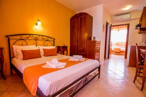 a bedroom with a bed with two towels on it at Xenonas Apollon in Sarti