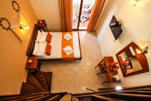 a view of a room with a bed and a staircase at Xenonas Apollon in Sarti