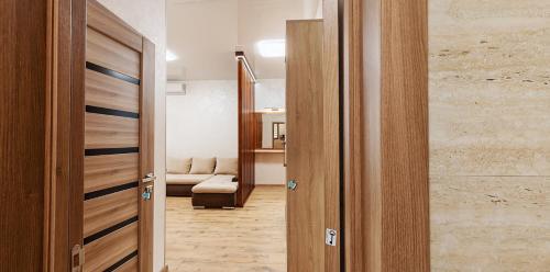 a hallway with two wooden doors and a living room at Апартаменти КАРПАТИ in Karpaty