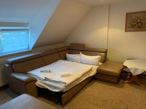 a hospital room with a bed and a chair at Hotel & Restaurant Schenk von Landsberg in Teupitz