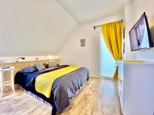 a bedroom with a bed and a flat screen tv at Metsa Apartments in Pärnu