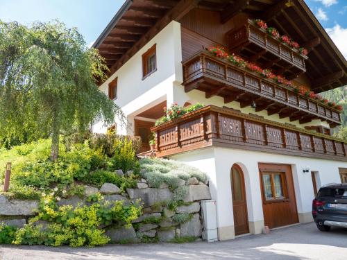 a house with a balcony with flowers on it at Haus Marianne in Sankt Jakob in Defereggen