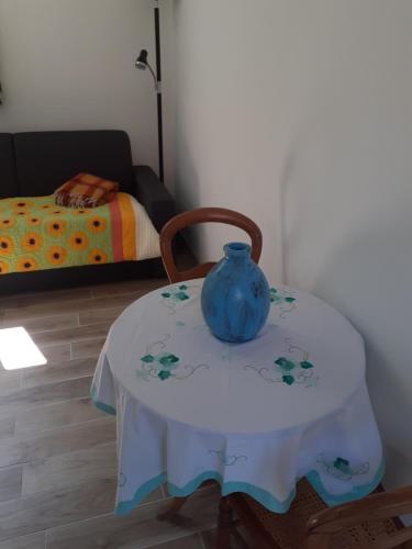a table with a blue vase sitting on top of it at studio près du Mont Saint Michel in Champeaux
