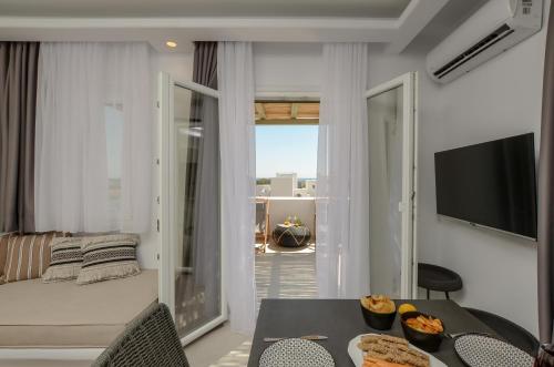 a living room with a table with food on it at Sea & Olives Suites Hotel and Villas in Plaka