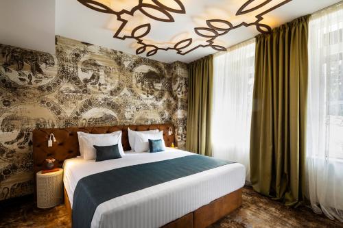 a bedroom with a large bed and a wall with graffiti at Gallery 37 Powered by ASTON in Plovdiv
