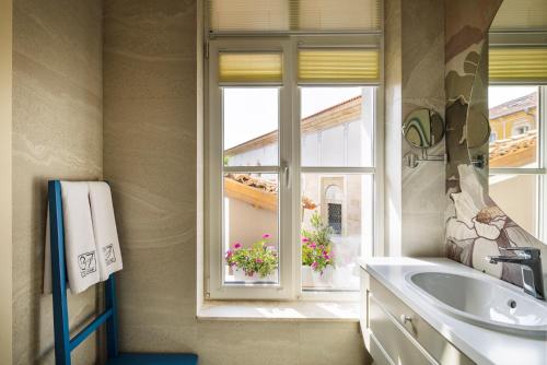 a bathroom with a sink and a window at Gallery 37 Powered by ASTON in Plovdiv