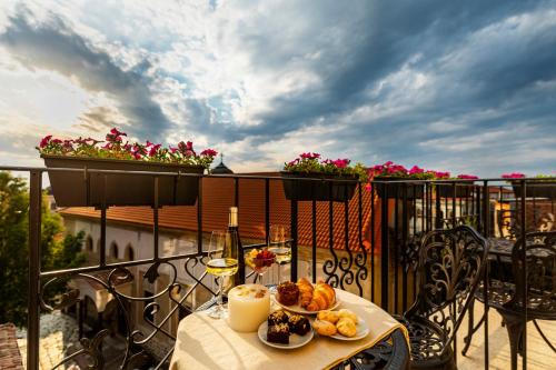 a table with food on top of a balcony at Gallery 37 Powered by ASTON in Plovdiv