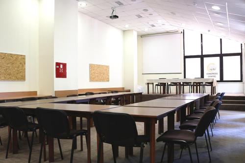 a group of tables and chairs in a room at Hotel Pela in Ohrid