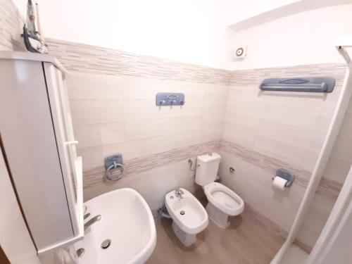 a bathroom with a toilet and a sink at CASA VACANZE ANDREANA in Letojanni