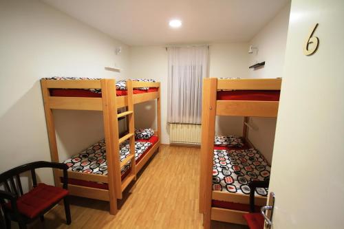 a room with three bunk beds in a room at Hostel Vrba in Ljubljana