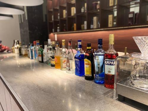 a row of bottles of alcohol sitting on a counter at Hotel Bay Gulls in Tajiri